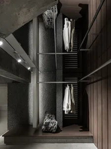 Minimalist clothing store featuring concrete, cedar, and stone materials