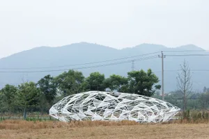 A modern architectural structure made of a white geometric lattice