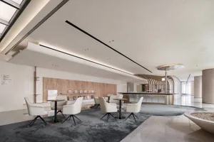 Modern minimalist coffee shop featuring sleek steel, transparent glass, and warm wooden elements.