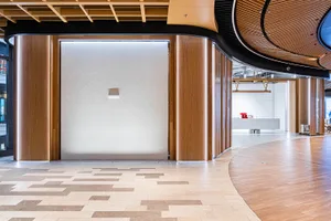A modern commercial entryway featuring wooden columns and glass panels.
