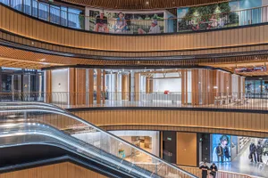 Modern industrial retail mall interior featuring contemporary design elements including wood, glass, and metal materials.