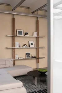 Modern living room featuring metal shelves, minimalist decor, and a sleek beige sofa