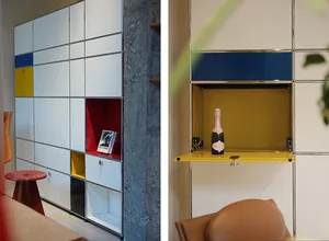 A modern interior storage cabinet with color-blocked compartments and metal frames.