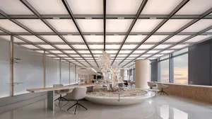 A modern office space featuring a marble sculpture, glass tables, and sleek metal accents.