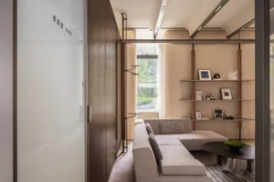 A modern minimalist living room with a fabric sofa.