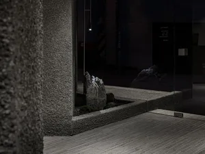 Minimalist lobby interior featuring polished concrete floors and glass details.