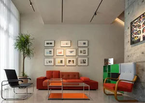 A modern living room with concrete walls, glass coffee tables, and a red sofa.