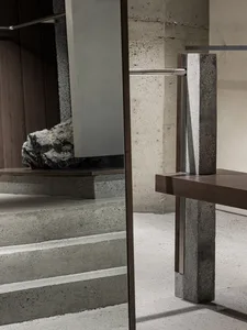 Modern interior design featuring concrete stairs and a wooden platform.