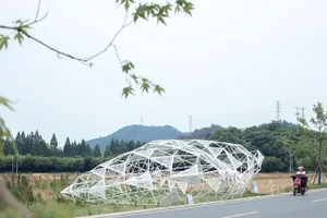 Geometric white metal framework installation amidst greenery