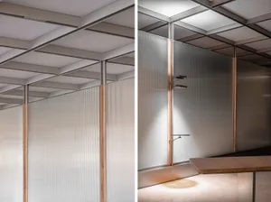 A modern office environment featuring see-through glass walls.