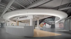 Modern office lobby with concrete walls and glass partitions