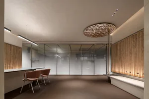 A modern reception area featuring a clean, minimalist design with natural wood accents.