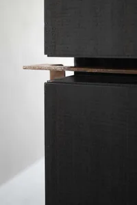 Close-up of a metallic storage unit with black metal finish