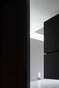 Minimalist interior design featuring concrete walls and glass elements.