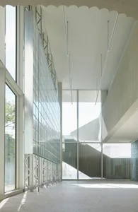 Modern architectural interior with large glass panels and concrete walls