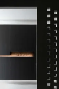 Modern interior design featuring a textured wooden wall with a light fixture and geometric lighting pattern.