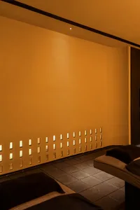 A spa room with tiled flooring and a patterned wall design.