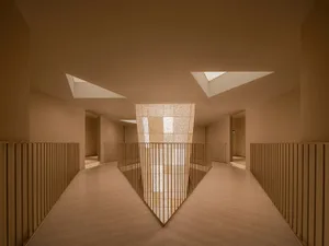 Industrial-style corridor with concrete walls and lighting.