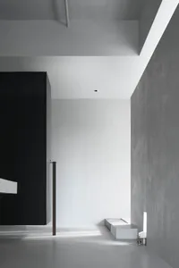 Minimalist white interior space with concrete walls and floor.