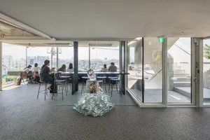 A modern cafe interior with glass blocks and concrete features.