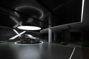A black metallic BMW SUV showcased in a dimly lit, modern automotive showroom with illuminated signage.