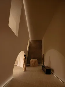 A modern minimalist bedroom made of concrete materials.