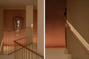 Modern staircase featuring metallic artwork against textured wall