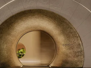 A modern lounge area with a textured concrete wall.