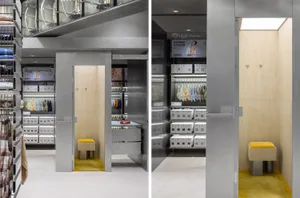 A modern fashion accessories store with metal shelving, glass display cases, and artificial lighting.