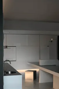 Modern minimalist kitchen with concrete countertops and floor.
