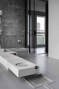 Minimalist bathroom with concrete sink and wall, industrial-style decor.