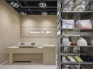 A modern retail store with metal shelving displaying products.