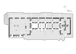 An overhead view of an industrial office layout showing concrete flooring and rectangular offices.