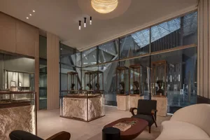 Exhibition hall in a modern art museum with glass walls and stone display cases.