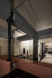 A modern clothing store featuring concrete and glass materials with minimalist design.