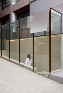 A modern outdoor spa with concrete and glass materials