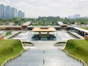 Modern public space featuring glass, steel, and concrete elements.