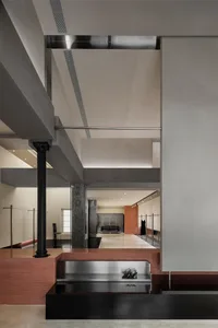 A modern retail store interior featuring exposed concrete, metallic accents, and minimalist design elements.