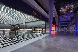 Modern retail storefront with geometric design and glass and concrete materials.
