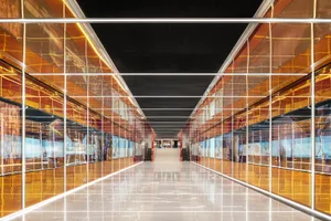A modern shopping center with glass walls and polished floors.