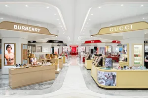 A luxurious retail store featuring white marble finishes and a spacious layout.