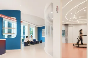 A modern hospital lobby showcasing plaster and glass design elements.