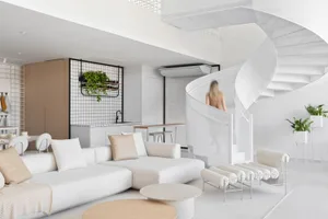 A modern living room with white furniture and decor.
