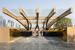 A modern public entrance featuring glass, metal, and cement materials