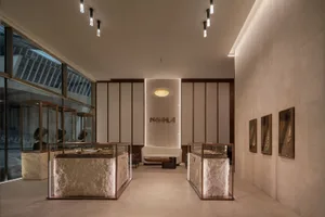 Modern retail storefront with glass display cases and stone bases showcasing jewelry.