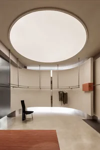 Modern clothing retail store with metallic clothing rack and minimalist design.
