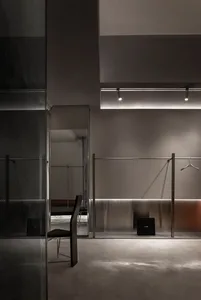 Modern minimalist clothing store with metallic finishes.