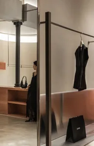 A modern retail store with transparent glass walls and a minimalist design.
