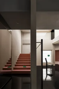 Modern interior with wooden staircase and hallway. Wide-angle view showing contemporary design elements.