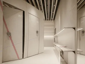 Minimalist clothing retail store with textured fabric walls